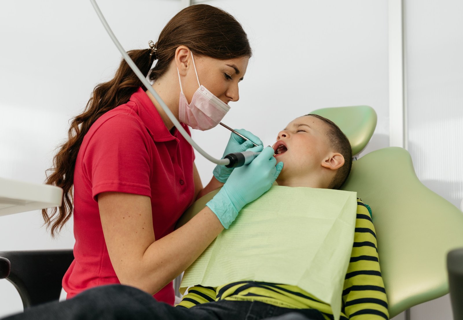 A child with a dentist in a dental office.